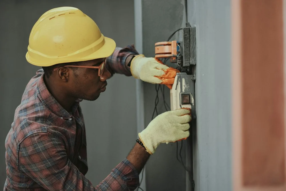 Service professional performing electrical work at a customer location